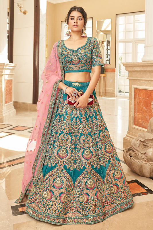 New Designer Teal Colored Lehenga Choli In Heavy Velvet With Embroidered Net Dupatta - Marriott Fashion